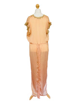 A peach-colored satin nightgown or long dress displayed on a mannequin.