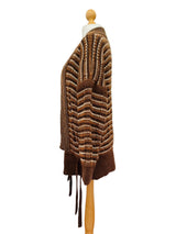 A brown and beige striped knit cardigan sweater displayed on a wooden dress form mannequin.