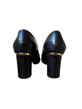 black shoes with gold accents