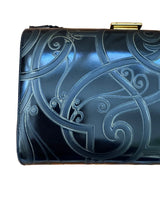 Black embossed leather clutch bag