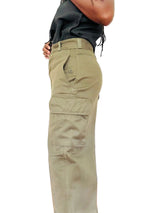 A person wearing high-waisted, light khaki cargo pants with side flap pockets, paired with a dark top,
