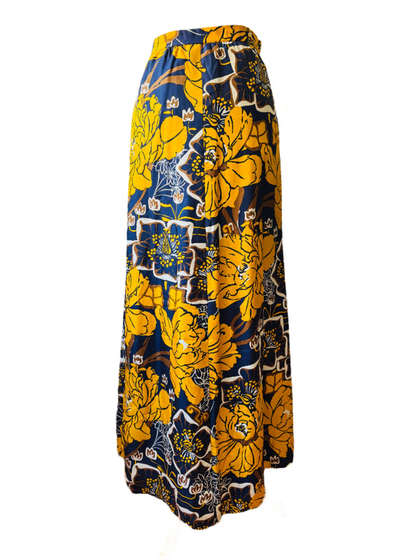 Mannequin wearing a blue and yellow floral patterned skirt indoors.