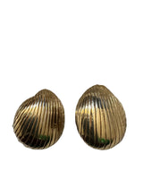Pair of gold shell-shaped earrings on a white background