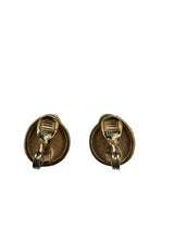 Two gold earrings on a  white background