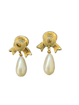 Pair of gold earrings with pearl drops.