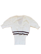 White sweater with burgundy stripes.