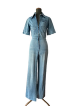 Light blue denim jumpsuit on a mannequin.